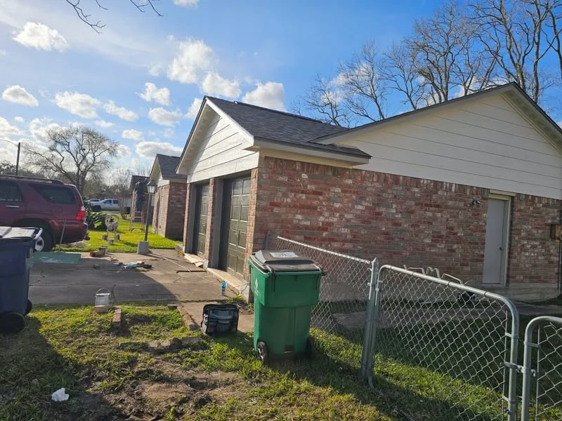 DeMilan exterior renovation with white siding and brick