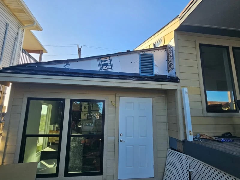DeMilan black metal awning installation on a Freeport home