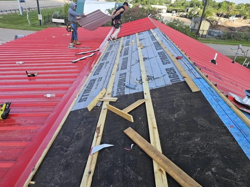 DeMilan red commercial metal roof installation in progress